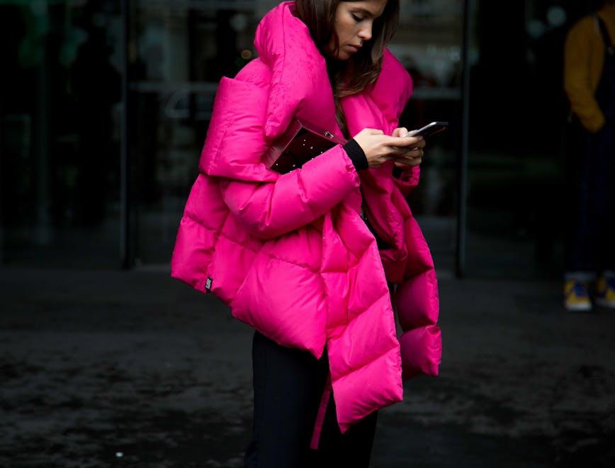 clothing apparel human person coat overcoat jacket phone electronics