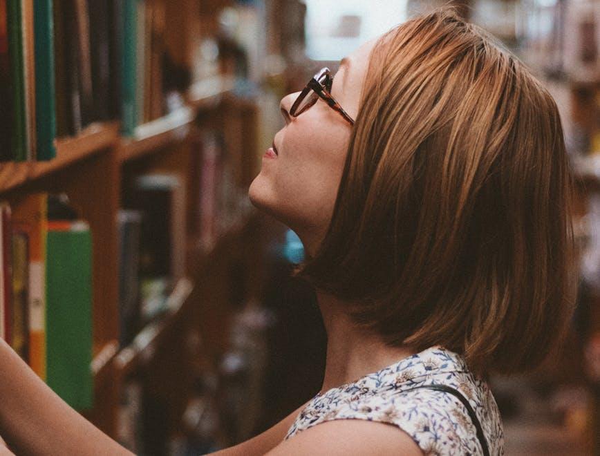 person human shelf furniture indoors room bookcase hair