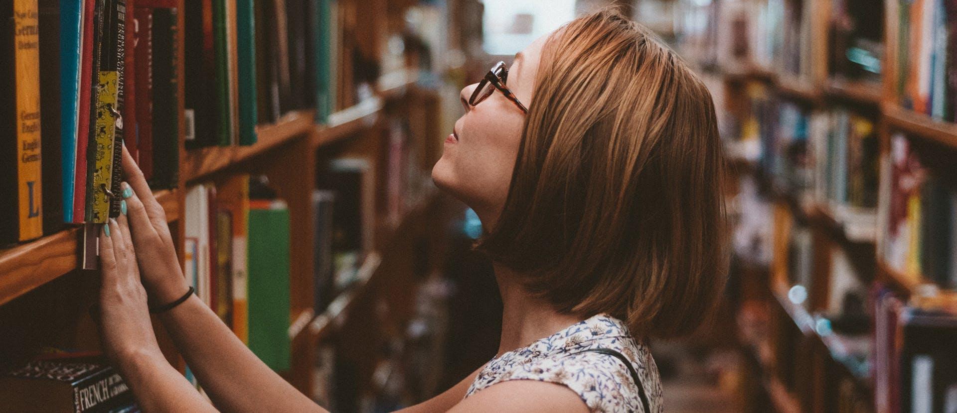 human person shelf furniture indoors room bookcase hair