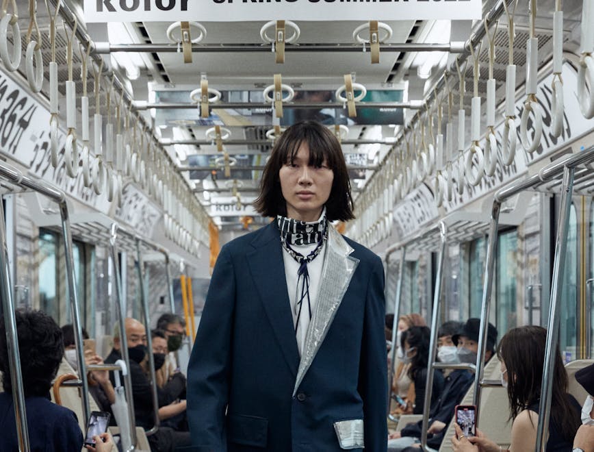 clothing person shoe train station transportation terminal train suit overcoat coat