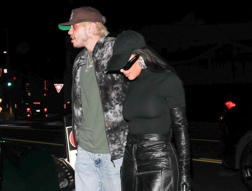 kim kardashian, pete davidson, giorgio baldi, santa monica, comedian, fashion, style, restaurant, meal, dinner, food, black boots, leather skirt, gloves, hat, sunglasses, green t-shirt, jeans, sneakers, love bite, hickey santa monica ca clothing apparel person human footwear pants