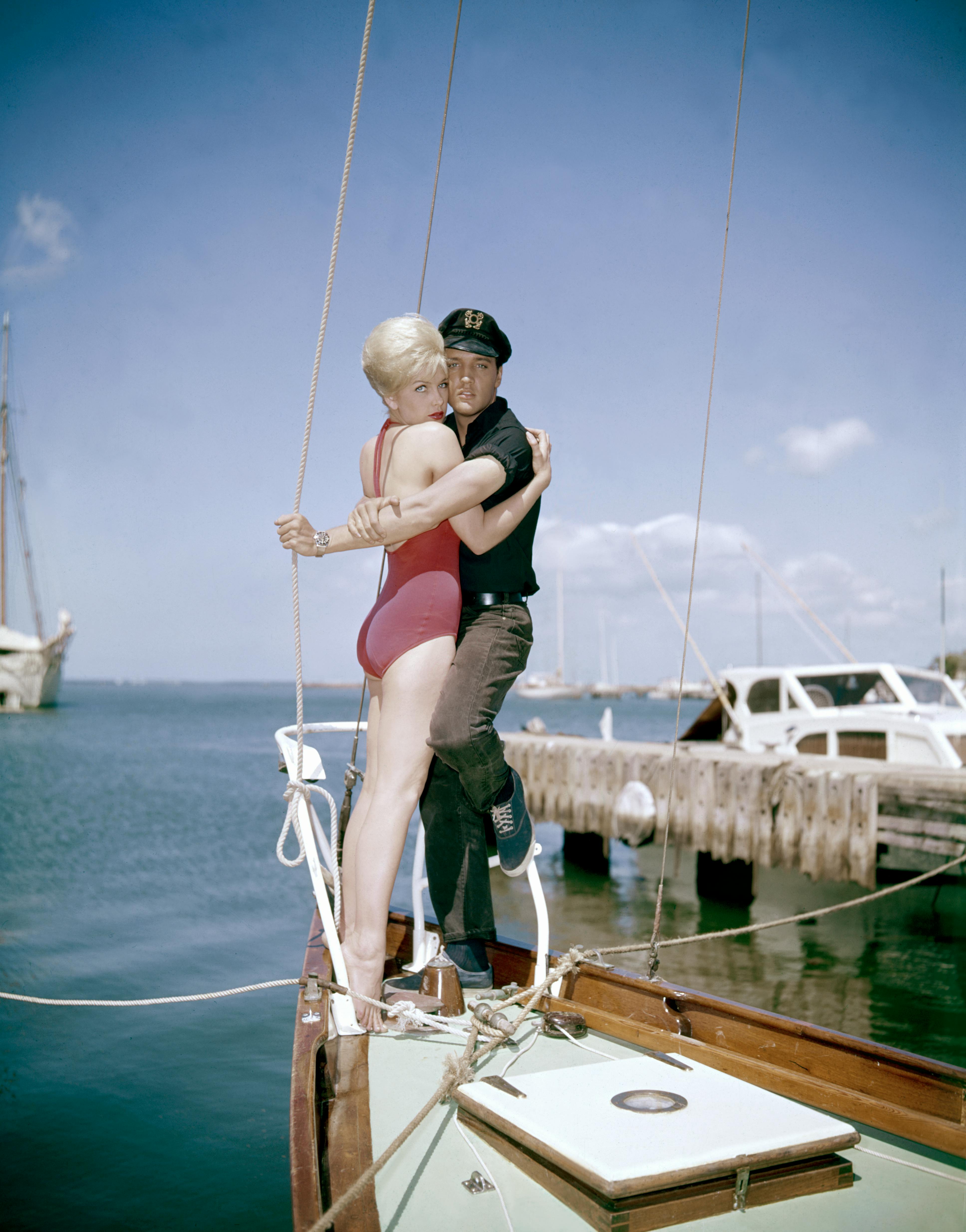 1960s two people young adult man young adult woman caucasian ethnicity movie set sailboat actress actor performing arts singer music celebrities hugging american movie film still hawaii elvis presley stella stevens person watercraft vehicle transportation water clothing waterfront pier wood boat