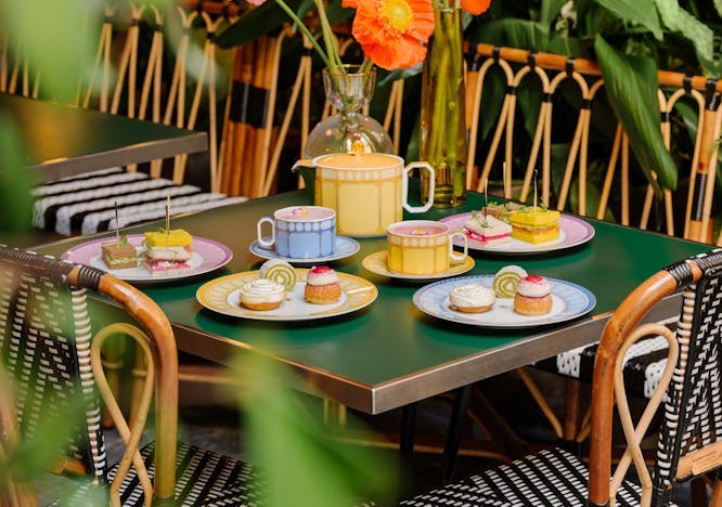 indoors restaurant cafeteria flower flower arrangement dining table table cup flower bouquet tabletop