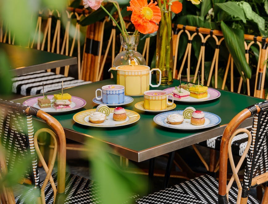 indoors restaurant cafeteria flower flower arrangement dining table table cup flower bouquet tabletop