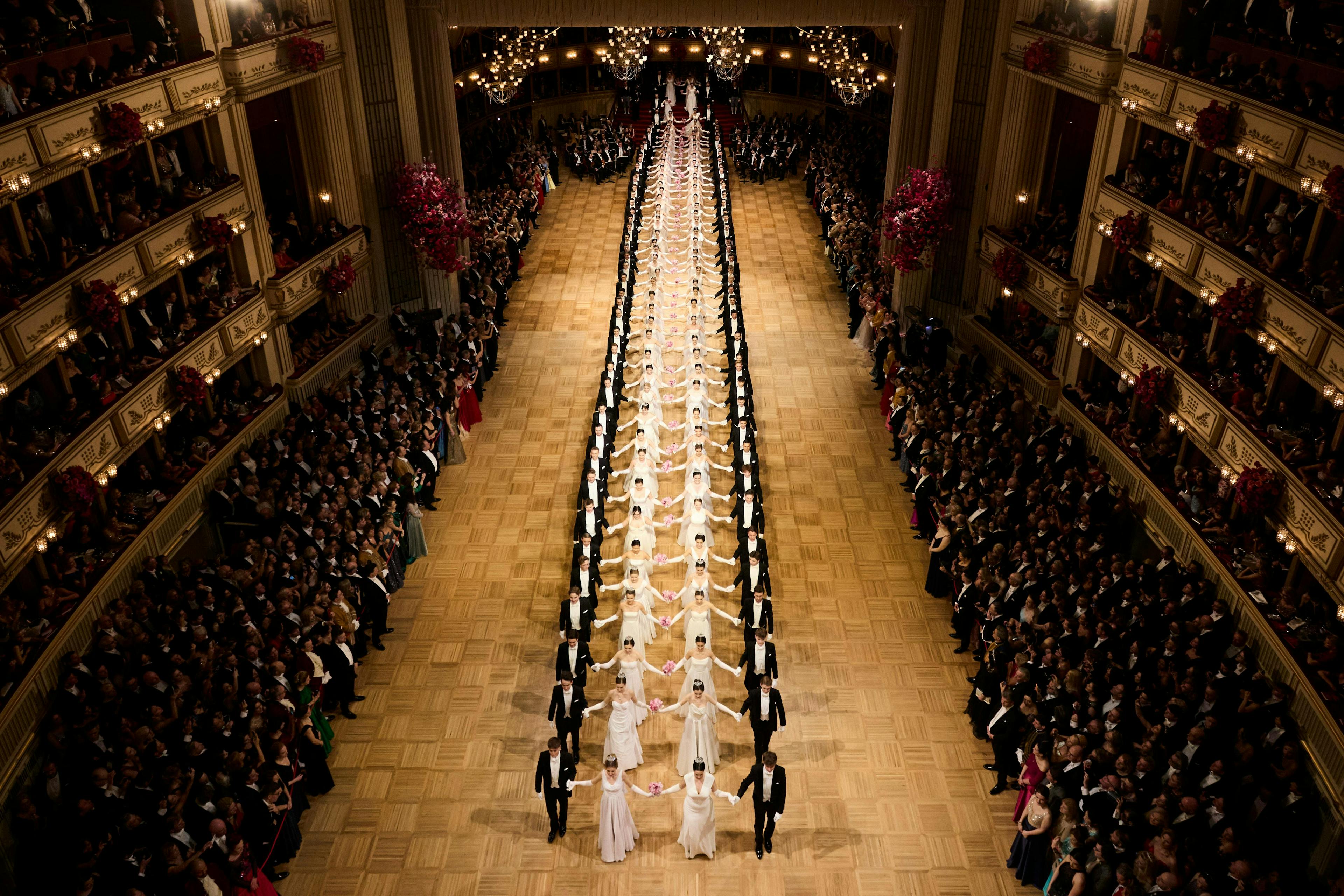 people person aisle indoors building auditorium hall theater chandelier crowd