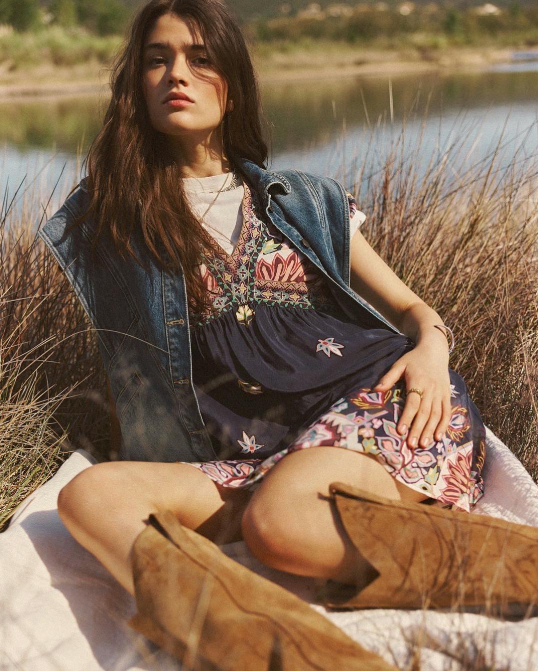 clothing pants person sitting beachwear jeans brown hair hair